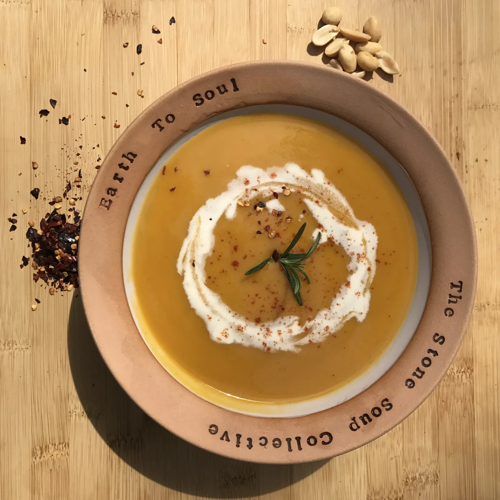 Carrot peanut soup in a handmade bowl